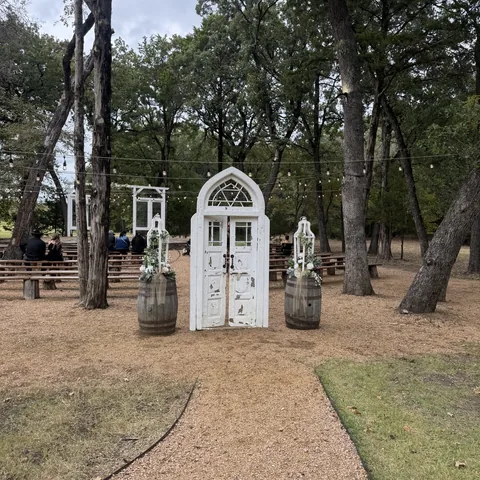 Outdoor wedding ceremony arch at The Establishment Barn in Terrell