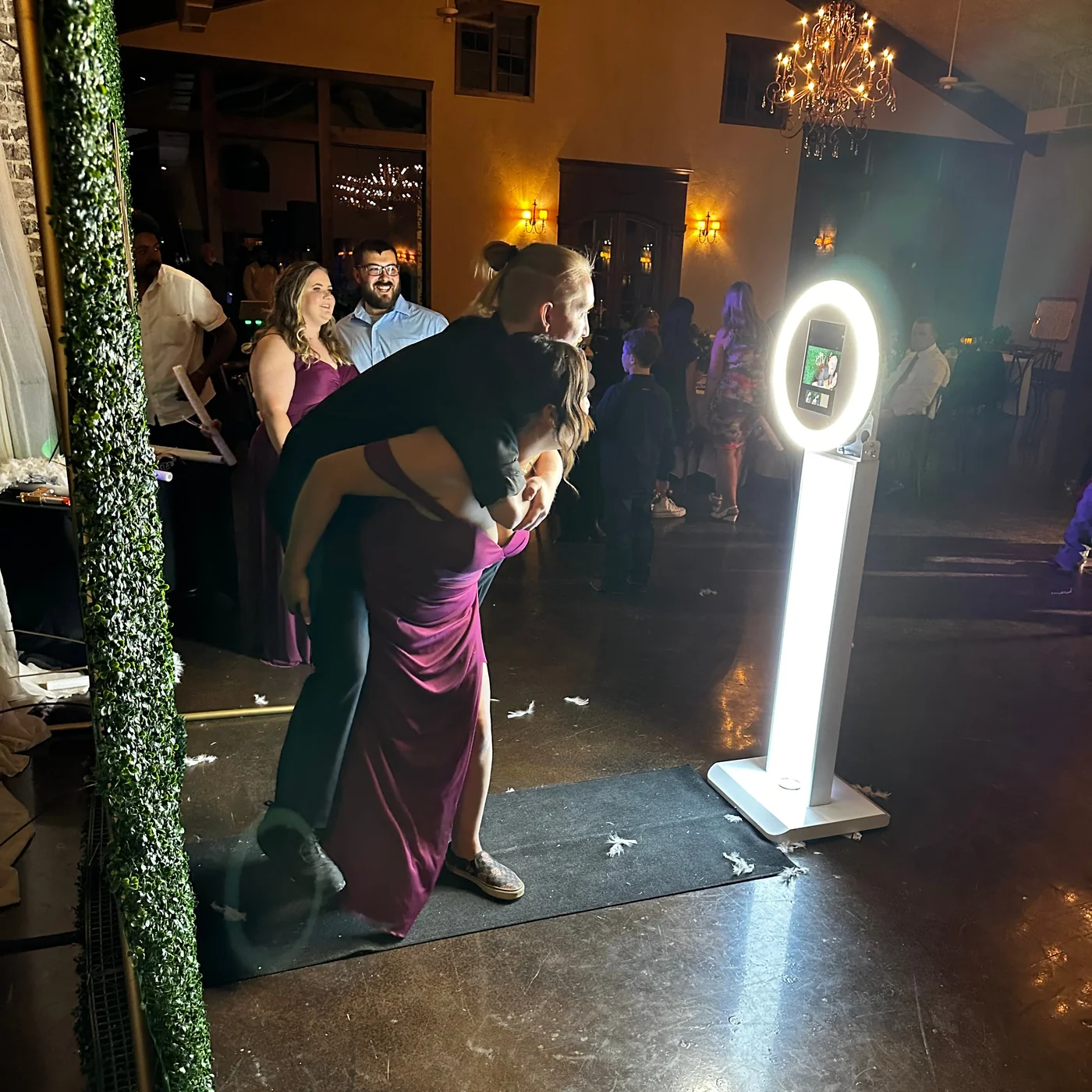 Couple posing together beside the Rosy Cheeks photo booth