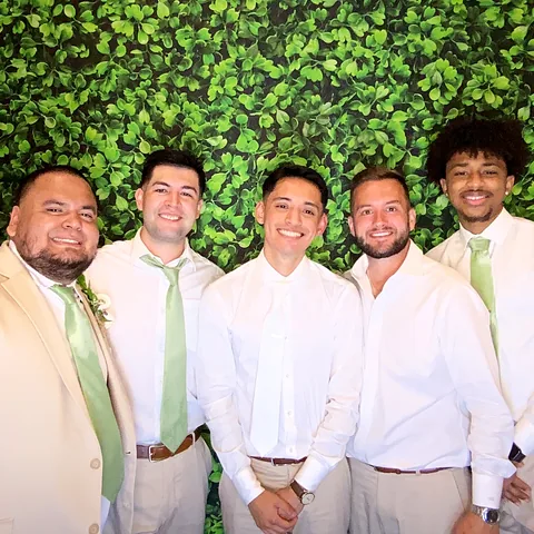 Groomsmen posing together at the photo booth at a Terrell, Texas wedding