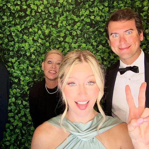 Guest flashing a peace sign at the Rosy Cheeks photo booth