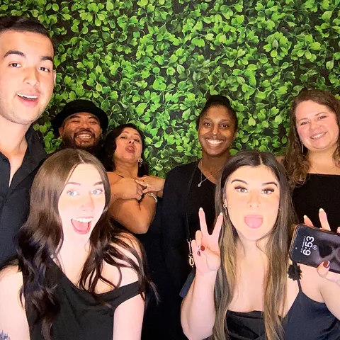 Wedding guests making silly faces at the photo booth