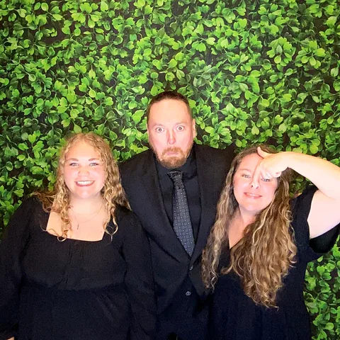 Three wedding guests smiling at the Rosy Cheeks photo booth