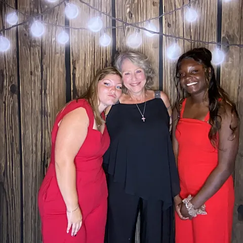 Friends leaning together for a photo at Tynli Timber Events