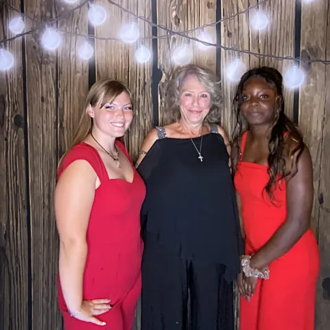 Three guests smiling together at London’s Sweet Sixteen